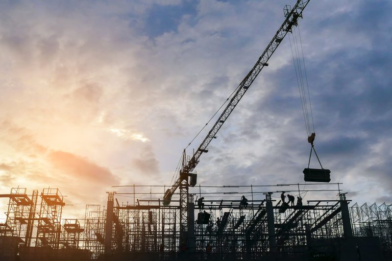 silhouette-the-group-of-workers-working-at-construction-site